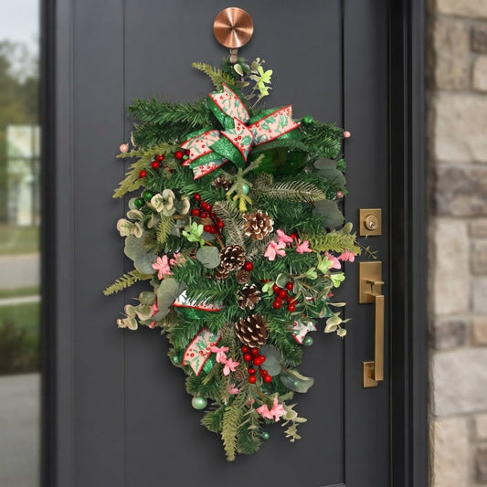 Emerald and pink Christmas teardrop swag displayed on dark front door