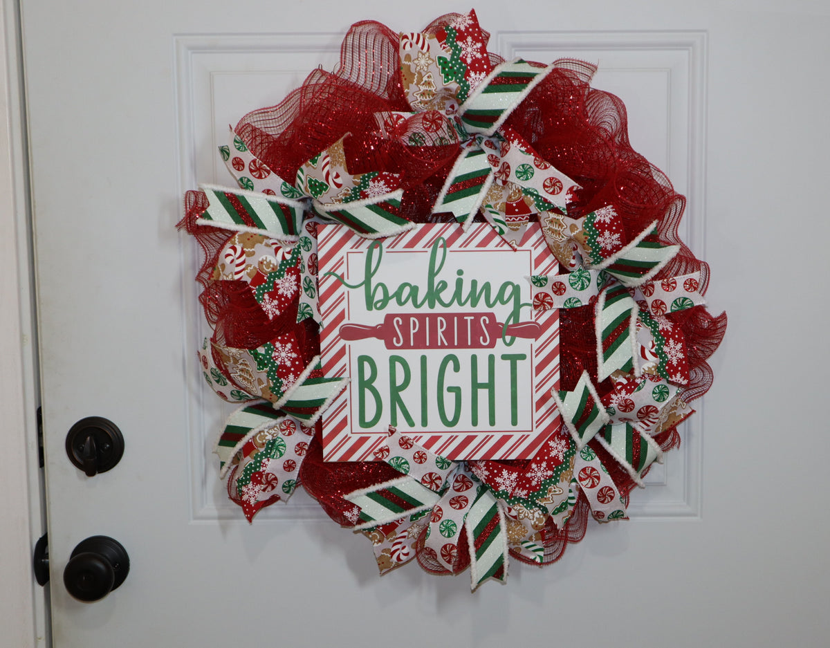 Handmade red Christmas baking wreath with gingerbread and peppermint ribbon