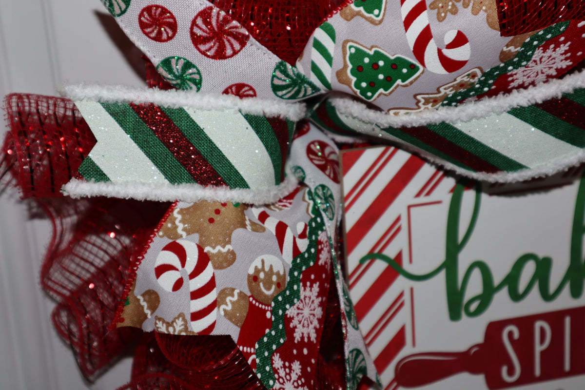 Close-up of gingerbread peppermint and striped wired ribbon on Christmas wreath