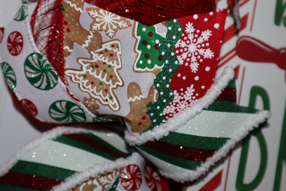 Gingerbread snowflake and striped ribbon detail on handmade Christmas wreath