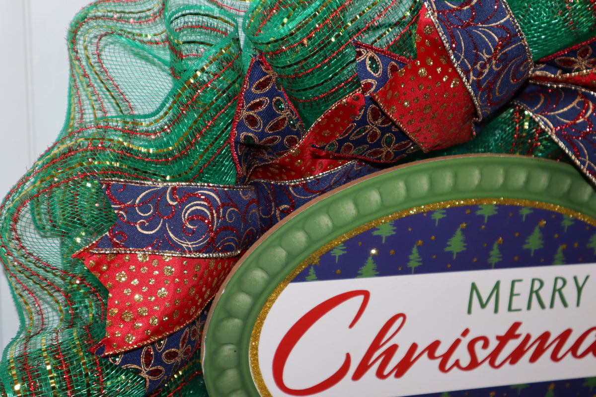 Close-up of Merry Christmas sign with green mesh and wired ribbon