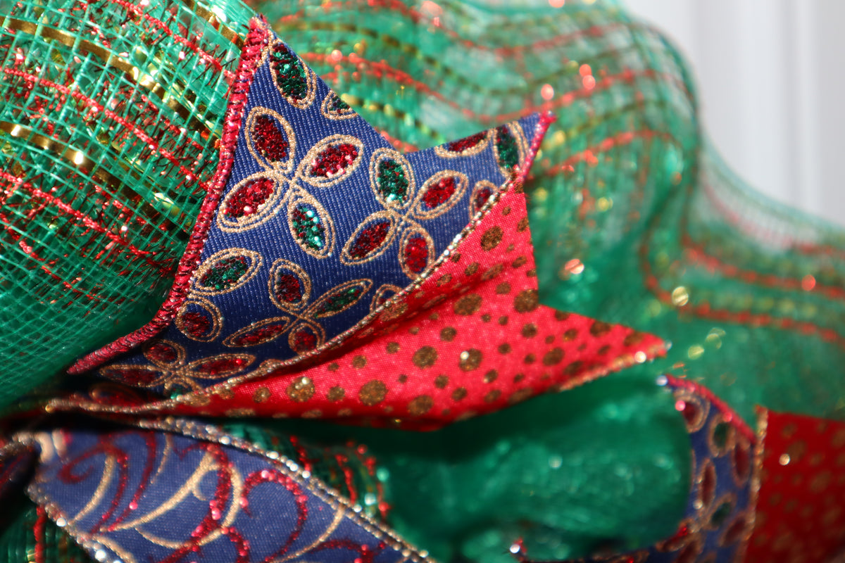 Close-up of red blue and gold wired ribbon on Christmas wreath