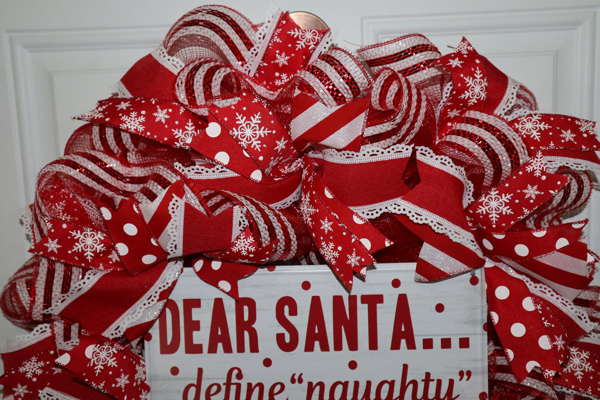 Close-up of snowflake polka dot and striped ribbon on Christmas wreath