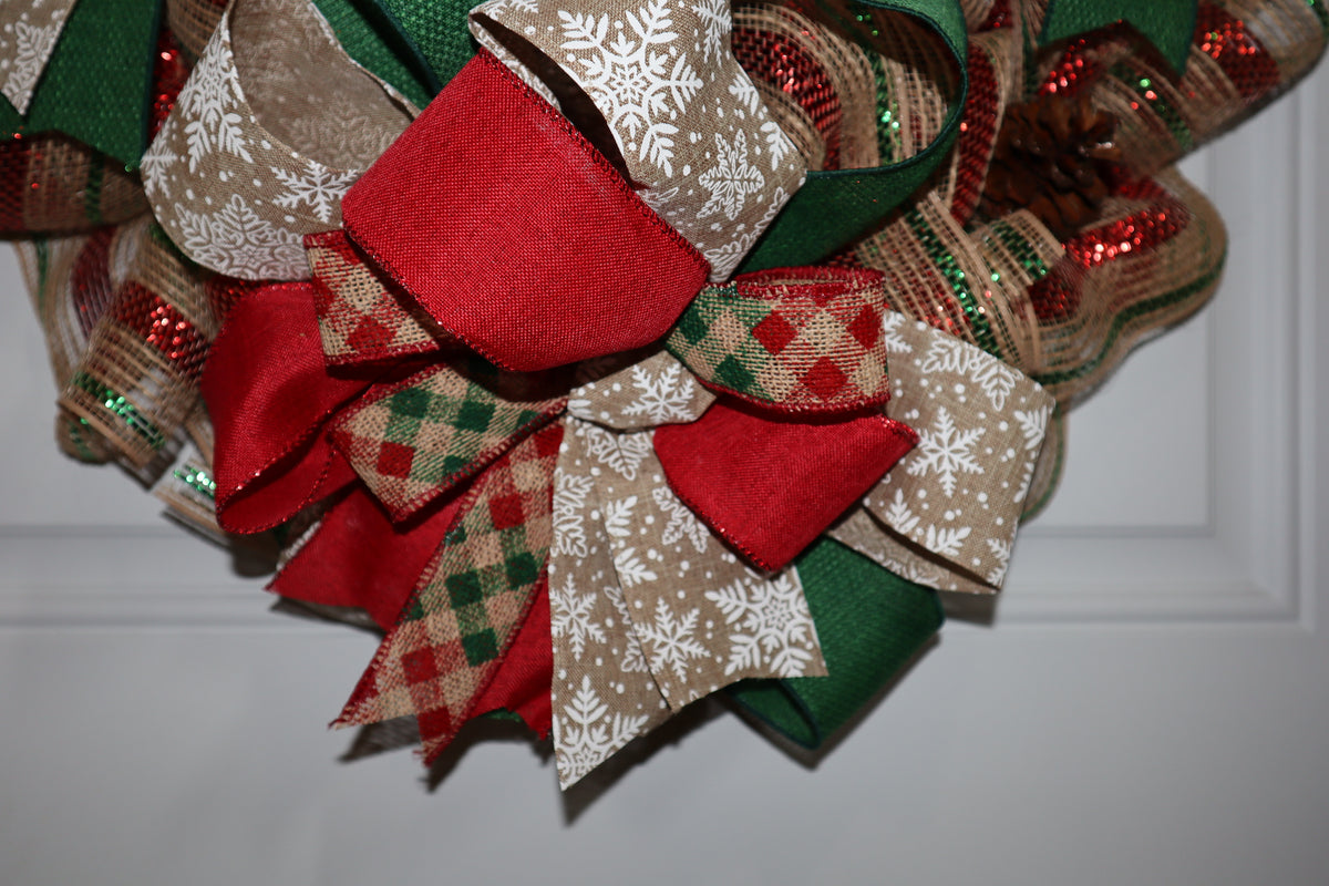 Layered red green plaid and snowflake ribbon bow on Christmas wreath