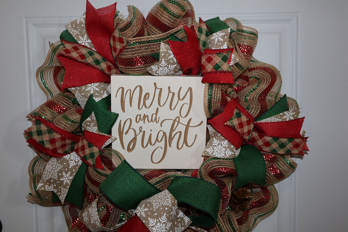 Close-up of handmade Merry and Bright Christmas wreath with wood sign
