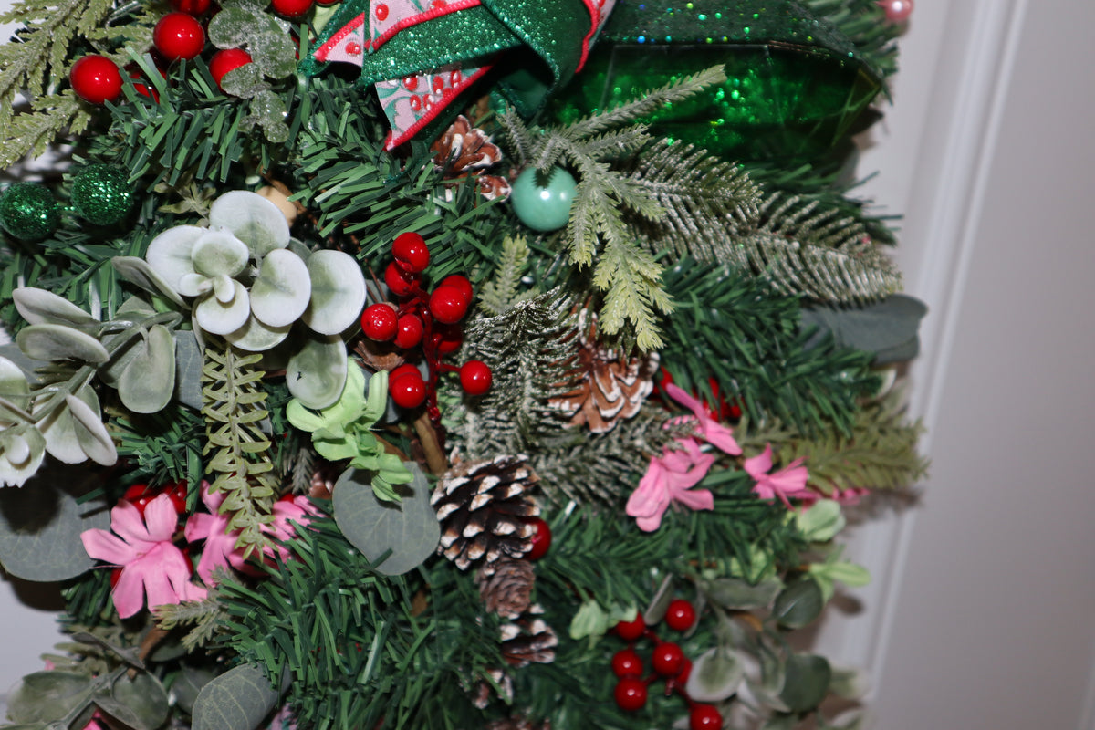 Mixed evergreen eucalyptus berries and pinecones on Christmas door swag