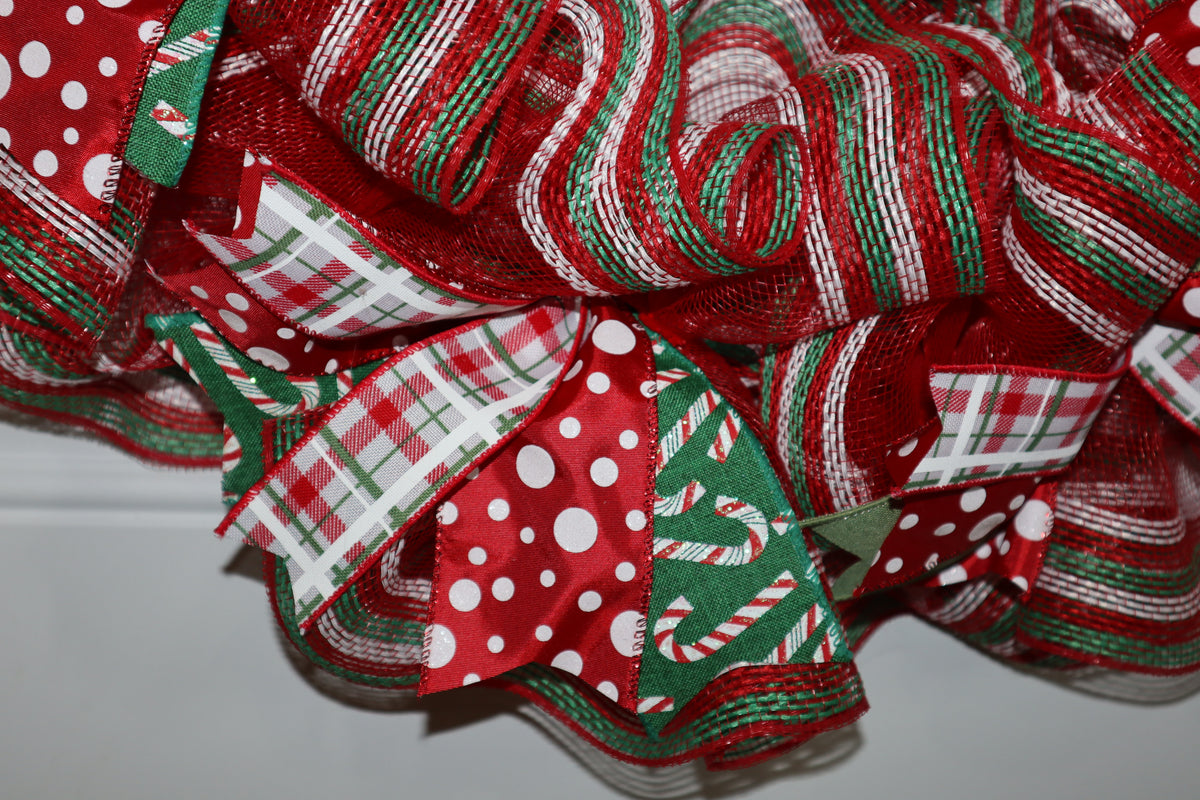 Red green and white deco mesh and Christmas ribbon detail