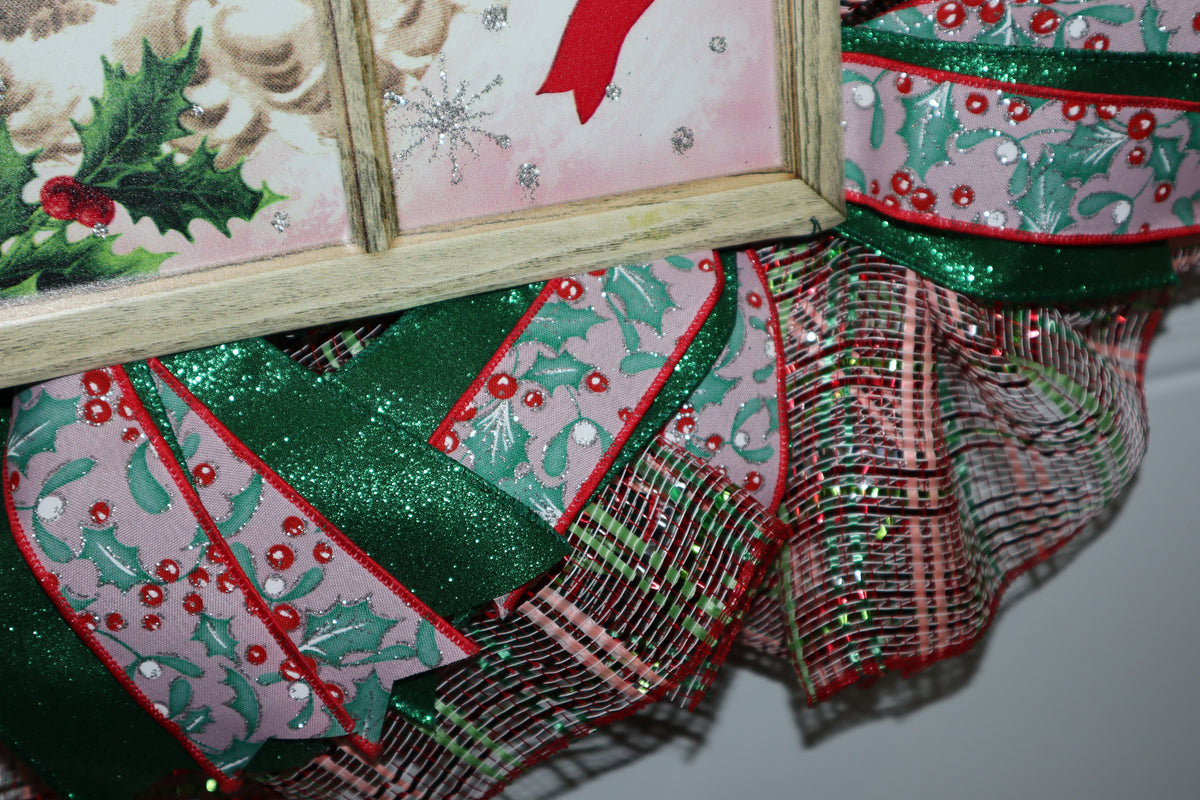 Close-up of holly ribbon and festive deco mesh on handmade wreath