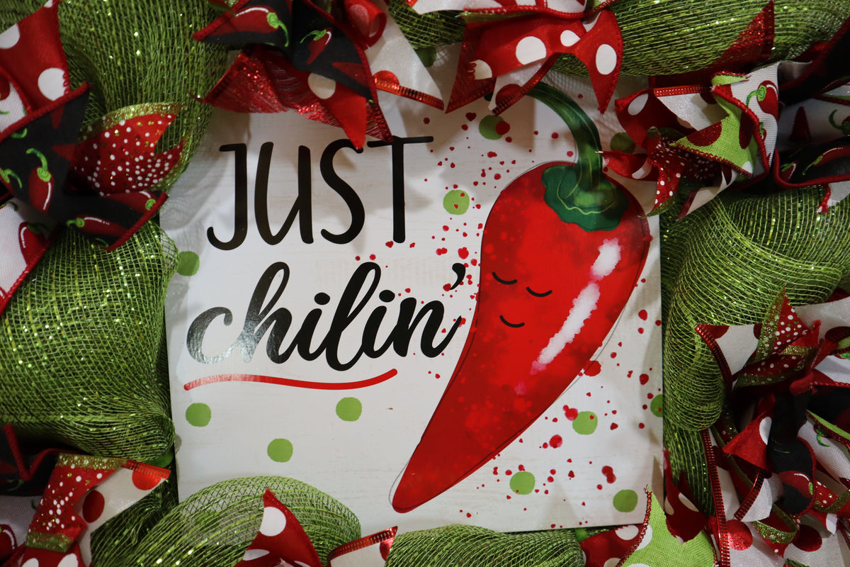 Close-up of chili pepper sign on handmade wreath