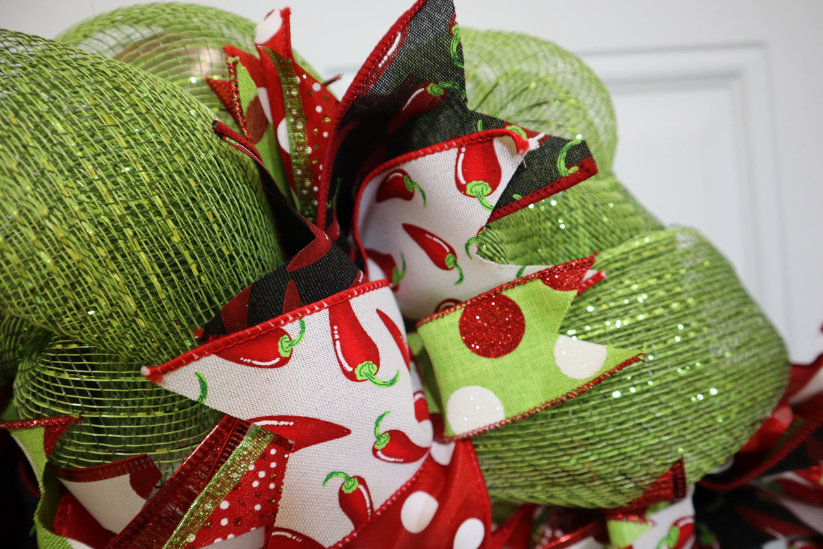 Green deco mesh and chili pepper ribbon detail on handmade wreath