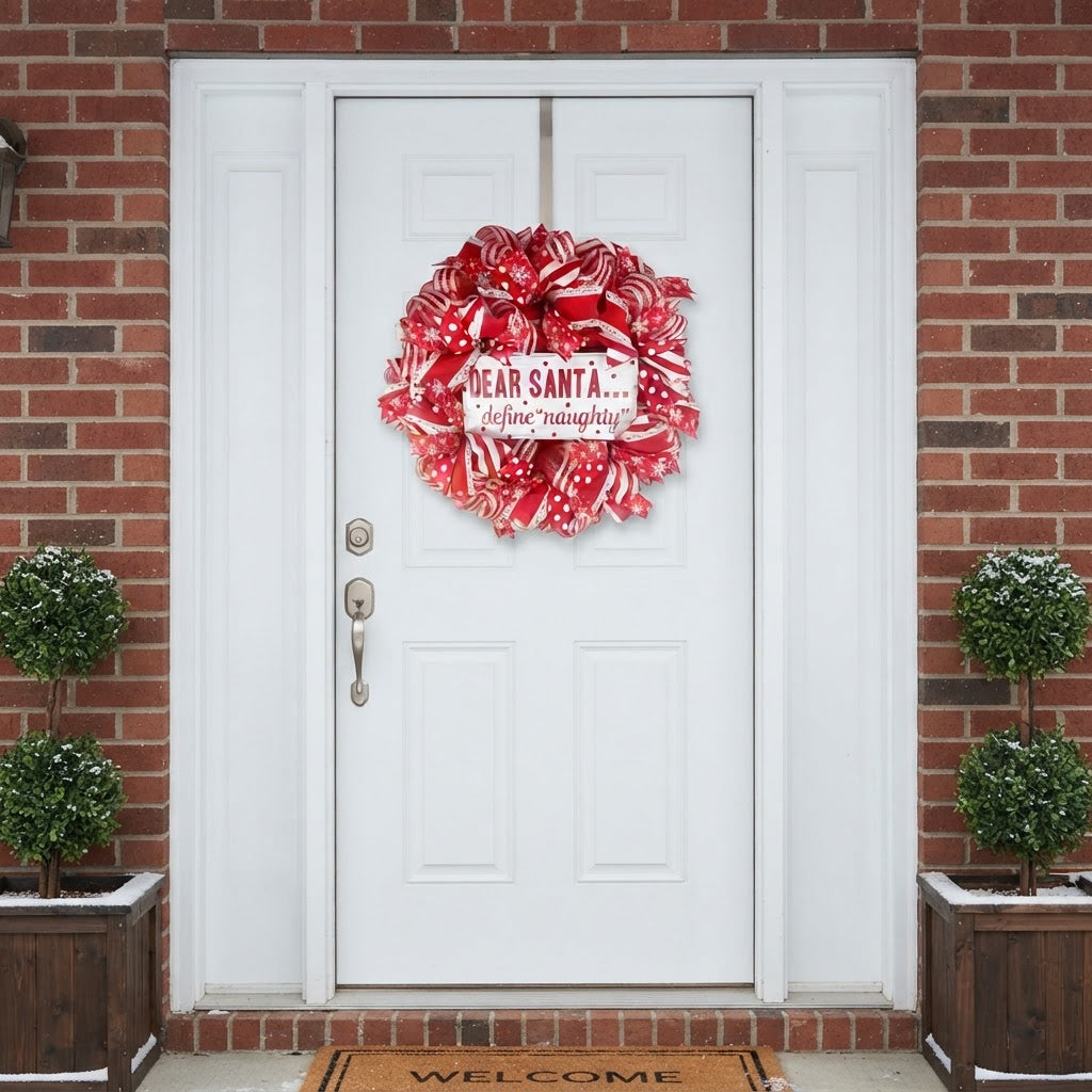 Red and white Christmas wreath displayed on white exterior front door