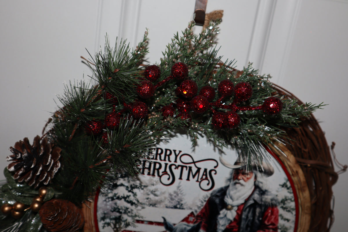 Close-up of red glitter berries and evergreen foliage on Christmas wreath