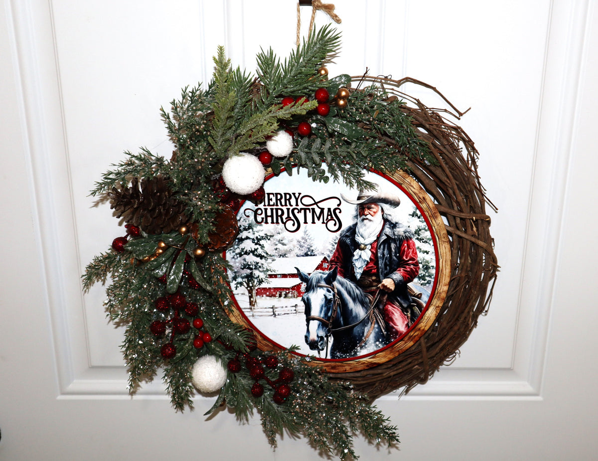 Handmade snowy western Christmas wreath displayed on white door