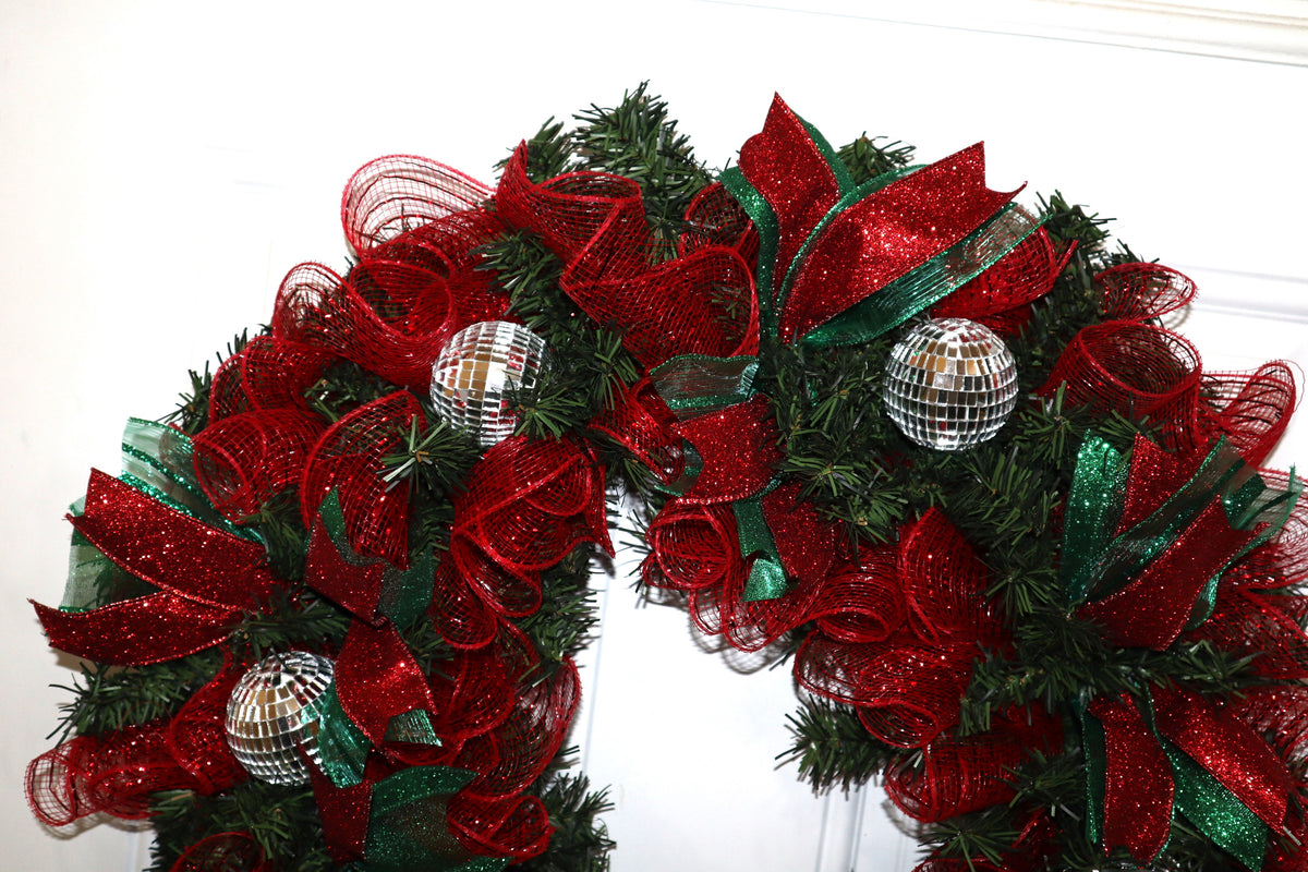 Close-up of handmade red and green Christmas wreath with silver disco balls