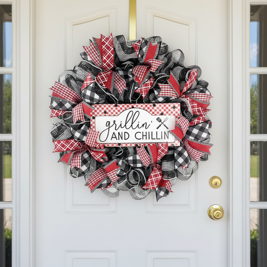 BBQ wreath displayed on a white front door