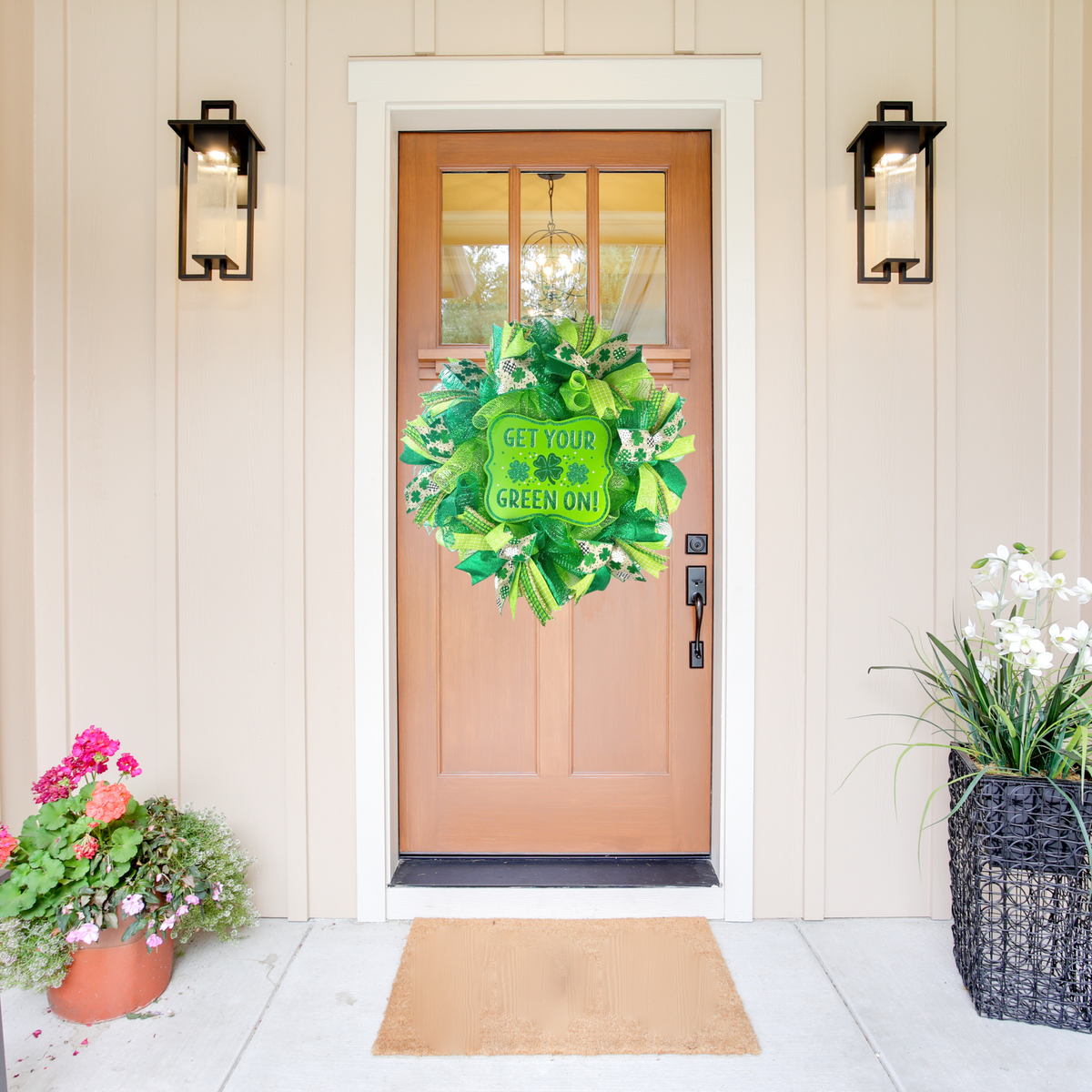 Green shamrock wreath displayed on a light wood front door